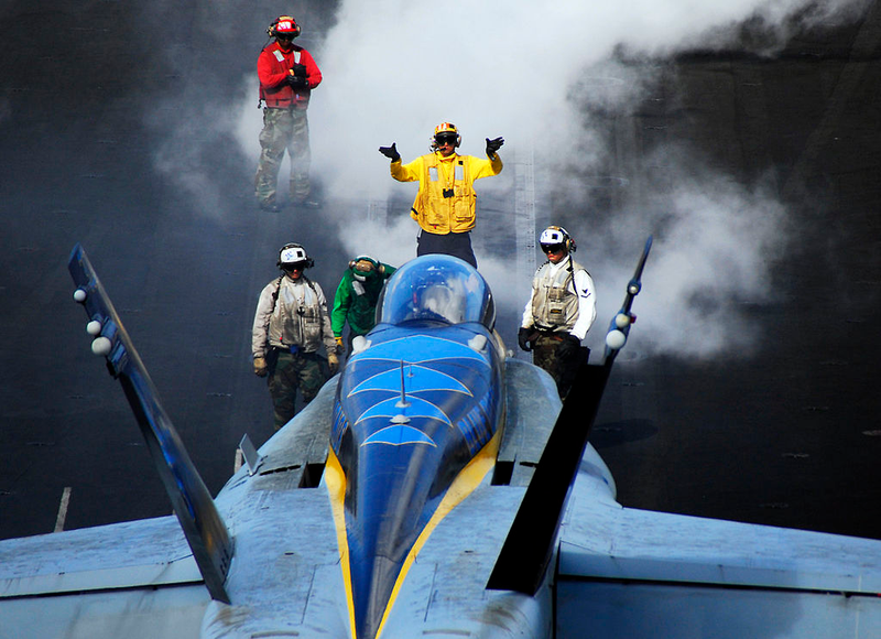 Illustration for article titled Here Is What All Those Colored Shirts Mean On An Aircraft Carrier's Deck